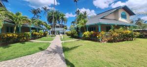 a house with a pathway in front of it at Villas Palmar Residence Beachfront Villas & Studios in Las Terrenas +29 photos