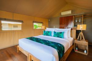 a bedroom with a large bed in a room at Kaura Manggis, Bali - Luxury Tent in Candidasa