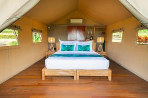 a bedroom with a bed in a small room at Kaura Manggis, Bali - Luxury Tent in Candidasa +107 photos