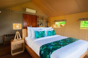a bedroom with a large white bed in a tent at Kaura Manggis, Bali - Luxury Tent in Candidasa