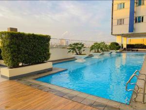 a swimming pool on the roof of a building at Sweden's Tiny Home, Studio Unit Condo in Manila