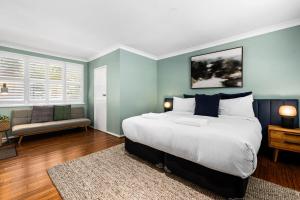 a bedroom with a large bed and a couch at Bendalong - Rural Retreat, Short Drive to CBD in Orange