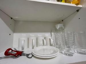 a table with a pair of scissors and glasses on it at Sweden's Tiny Home, Studio Unit Condo in Manila
