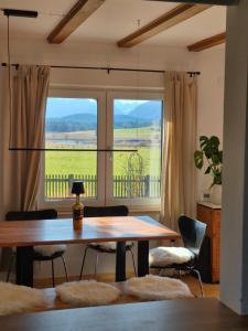 a dining room with a table and a large window at The Staffelsee Lodge in Uffing +28 photos
