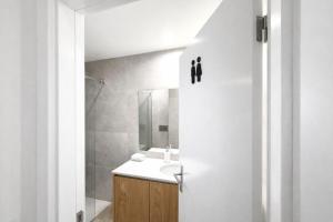 a white bathroom with a sink and a shower at Cc House Gaia 2 in Vila Nova de Gaia +27 photos
