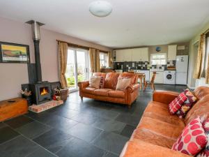 a living room with a couch and a fireplace at Blaenffynnon Bach in Carmarthen
