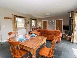 a living room with a wooden table and chairs at Blaenffynnon Bach in Carmarthen