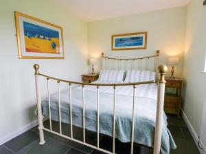 a bedroom with a bed with a white bed frame at Blaenffynnon Bach in Carmarthen