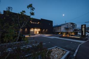 a view of a building with a parking lot at The Nine States Hotel KARATSU in Karatsu