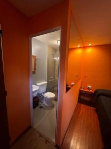a bathroom with a toilet and a sink and a door at Prisamata in Salta +50 photos