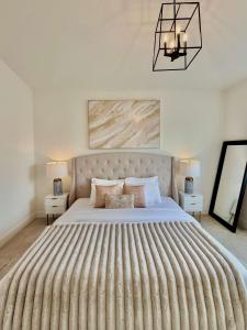 a bedroom with a large bed and two lamps at Luxury 3Br Oasis Gated Yard Pets Welcome in Langley