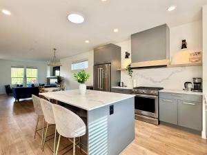 a kitchen with a kitchen island with white counter tops at Luxury 3Br Oasis Gated Yard Pets Welcome in Langley