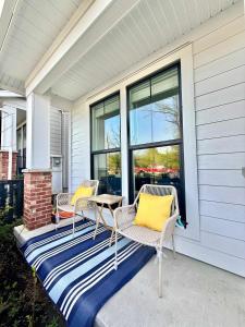 a porch with two chairs and a table on a house at Luxury 3Br Oasis Gated Yard Pets Welcome in Langley