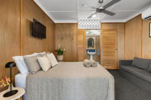 a bedroom with a large bed and a couch at Dolphins Backpackers in Sunshine Beach