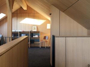 an office with wood paneled walls and a desk at Modern design house with sauna 'Arduenna Silva' in La-Roche-en-Ardenne
