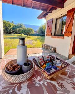 a table with a tray of food and a bottle of water at Cabañas Aldea Blanca in Merlo