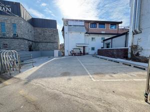 an empty parking lot in front of a building at The YoGwan in Suwon