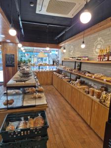 a bakery aisle with a lot of bread and pastries at Amant Hotel in Goyang