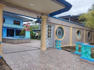 a house with a clock on the side of it at Hotel Alto Amazonas in Leticia