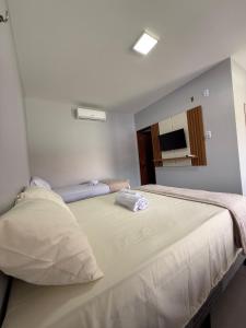 a bedroom with a large bed in a room at Chalés Brisas dos lençóis in Barreirinhas +14 photos