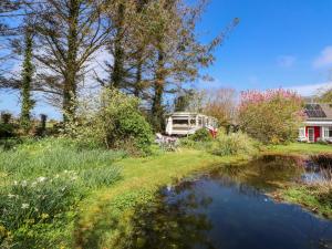 a camper is parked next to a pond at Fron Dderw Caravan in Holyhead