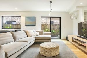 a living room with a couch and a table at Stone & Sand in Lennox Head