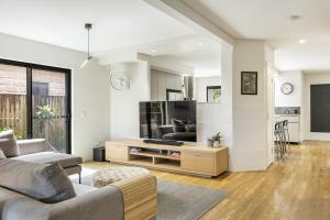 a living room with a couch and a tv at Stone & Sand in Lennox Head