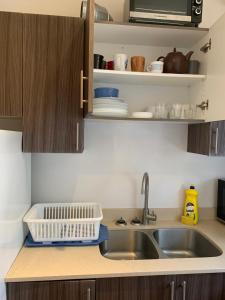 a kitchen counter with a sink and a microwave at Pembroke suites in Toronto +13 photos