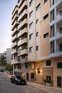 a black car parked in front of a building at Dakar Roi - Point E - Modern Studio - Central Location in Dakar