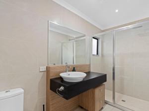 a bathroom with a sink and a shower at Time Out on Flinders in Indented Head +4 photos