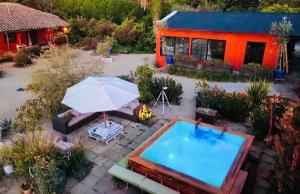 an overhead view of a backyard with a pool and a house at Strip Center Suites by Casona Lo Aguirre in El Monte