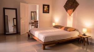 a bedroom with a bed and two lamps and a mirror at Ayeda Villa 2 in Krabi