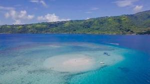 an island in the middle of a large body of water at Rainbow beach Bungalow in Matura
