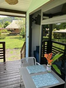 a table and chairs on the porch of a house at Rainbow beach Bungalow in Matura +5 photos