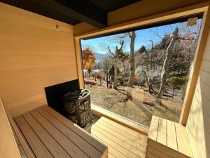 a window in a sauna with a bench and a barrel at りす村別荘 in Yamanakako +11 photos