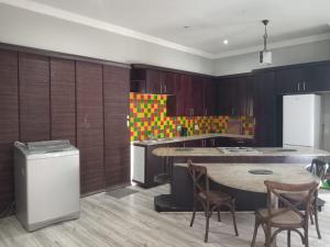 a kitchen with a table and chairs and a counter at UVongo Welcome House in Margate