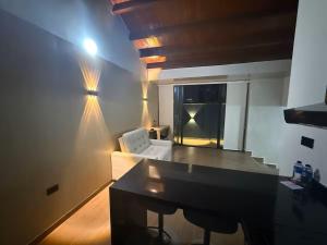 a living room with a white couch and a table at LoftBrothers39 in Bucaramanga +121 photos