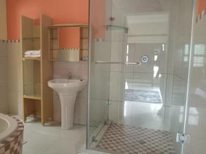 a bathroom with a glass shower and a sink at UVongo Welcome House in Margate +36 photos