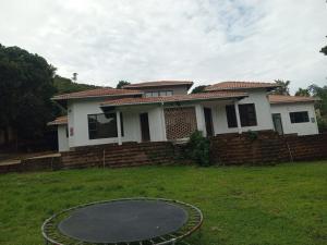a house with a trampoline in the yard at UVongo Welcome House in Margate