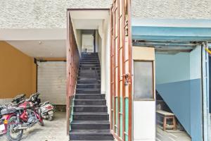 a staircase leading up to a building with motorcycles at Collection O Verena in Indore