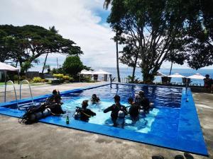 a group of people in the water in a swimming pool at Silver Reef Dive Resort in Dauin