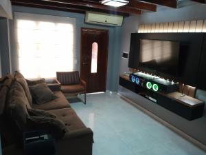 a living room with a couch and a flat screen tv at Apart hotel GAVA in Encarnación