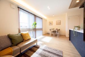 a living room with a couch and a table at jeje asahikawa in Asahikawa