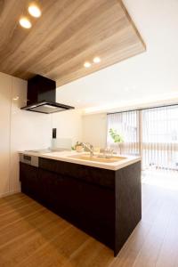 a kitchen with a sink and a large window at jeje asahikawa in Asahikawa
