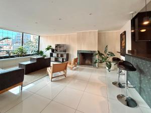 a living room with a fireplace and a couch at Hotel Tempo Rent in Santiago