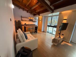 a living room with a white couch and a table at LoftBrothers39 in Bucaramanga
