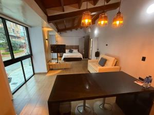 a living room with a table and a bedroom at LoftBrothers39 in Bucaramanga