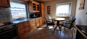 a kitchen with a table and chairs and a table and a table and chairsktop at Monteurwohnung in Patersdorf