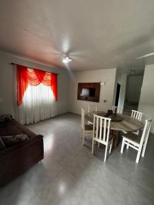 a living room with a table and a couch at Casa na Natureza Próx Pomerode e Timbó in Rio dos Cedros