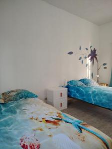 a bedroom with two beds and a palm tree mural at Arcadia 1 in Santiago